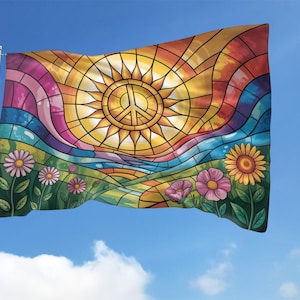 May include: A colorful flag with a stained-glass design featuring a sun with a peace symbol, a rainbow, and flowers. The flag is waving in the wind against a blue sky with clouds. The flowers include daisies and sunflowers.