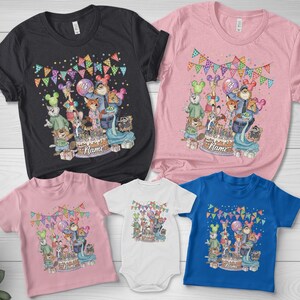 May include: A collection of t-shirts and a onesie in various colors, including black, pink, white, and blue. Each garment features a colorful cartoon design with a birthday theme, including a cake and animal characters. The text "Name" is visible.