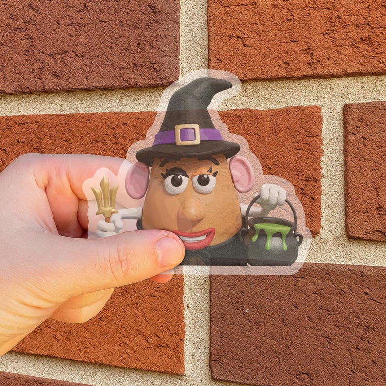 May include: A clear sticker featuring a cartoon potato head dressed as a witch for Halloween. The potato head wears a black hat with a purple band and holds a trident and a cauldron with green liquid.