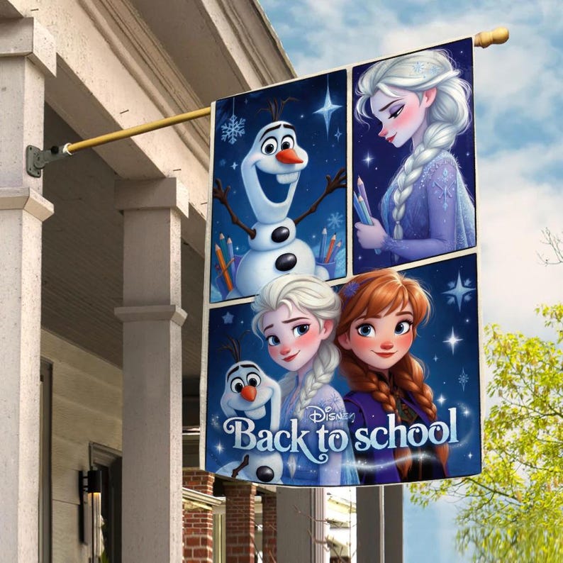 May include: A rectangular flag featuring characters from the Disney movie Frozen. The flag has four panels with images of Elsa, Anna, and Olaf. The text "Back to school" is displayed on the bottom panel. The flag is hanging from a gold-colored pole.
