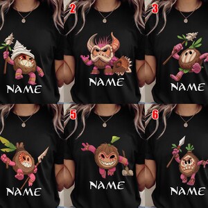 Puede incluir: Camisetas negras con personajes de dibujos animados de coco con varias expresiones y accesorios. Cada dise&ntilde;o incluye la palabra "NAME" en letras blancas debajo del personaje. Los personajes son en tonos de marr&oacute;n, rosa y blanco.