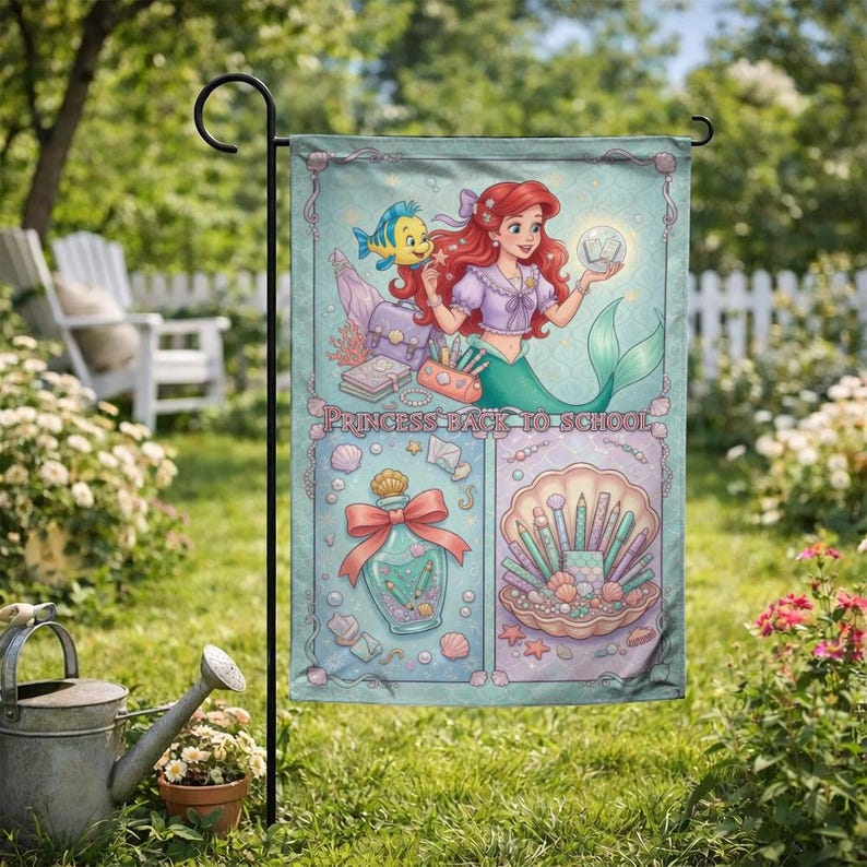 Puede incluir: Bandera de jard&iacute;n con una ilustraci&oacute;n de sirena pelirroja y un pez amarillo. La bandera tiene el texto "PRINCESS BACK TO SCHOOL" e incluye im&aacute;genes de &uacute;tiles escolares y una concha marina.