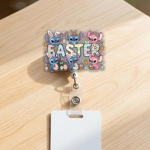 May include: A badge reel featuring cartoon characters with bunny ears, holding Easter eggs and baskets. The word "EASTER" is displayed in colorful letters. The reel has a clear plastic strap and a white rectangular tag.