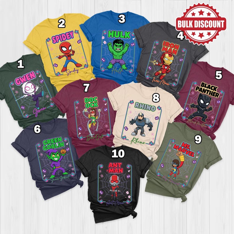 May include: Ten different t-shirts in various colours, each showcasing a superhero character. The shirts feature characters such as Gwen, Spidey, Hulk, Iron Man, Black Panther, Green Goblin, Doc Ock, Rhino, Ms. Marvel, and Ant-Man, with their names and graphics.