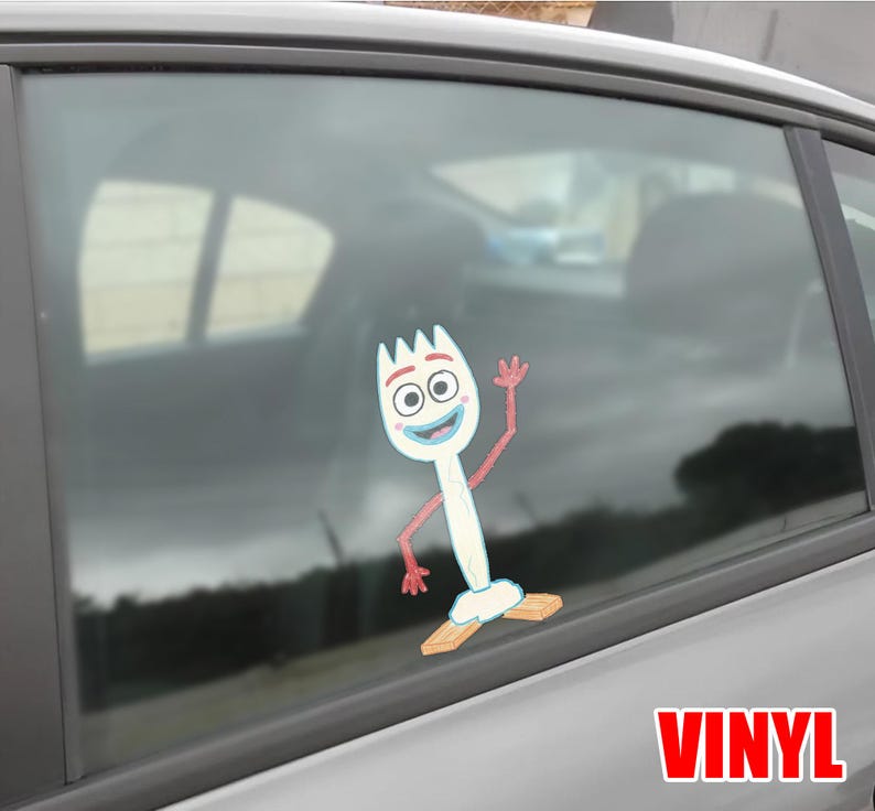May include: A white vinyl decal of the character Forky from the animated film Toy Story. Forky is waving with a smiling expression. The decal is affixed to a car window. The word "VINYL" is printed in red.
