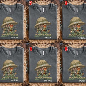 May include: Six grey t-shirts with a Zootopia theme. Each shirt features a safari hat with a family member's name and a graphic of Zootopia characters. The text "ZOOTOPIA TRIP 2026" is printed below the graphic.