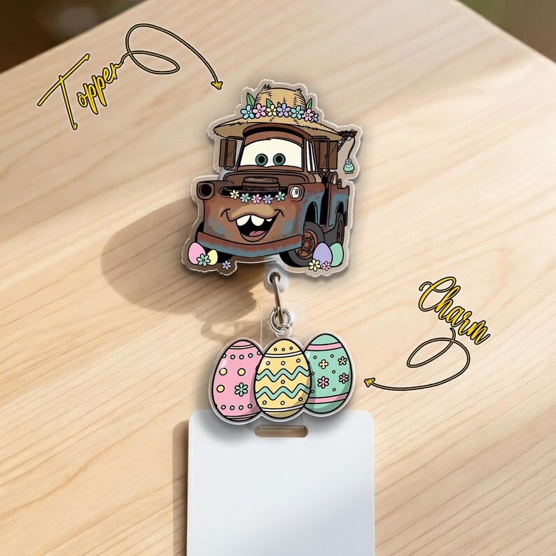 May include: A badge reel topper featuring a cartoon car character wearing a straw hat with flowers. Below the topper are three Easter egg charms in pink, yellow, and blue. The topper and charms are attached to a white badge holder.