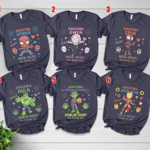 May include: Navy blue t-shirts with Marvel character designs, including Spider-Man, Gwen, Spin, Hulk, Green Goblin, and Iron Man. Each shirt displays a character graphic and text such as "Amazing Spider".