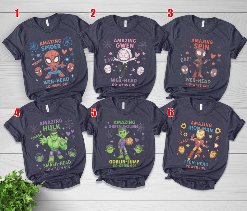 May include: Navy blue t-shirts with Marvel character designs, including Spider-Man, Gwen, Spin, Hulk, Green Goblin, and Iron Man. Each shirt displays a character graphic and text such as "Amazing Spider".