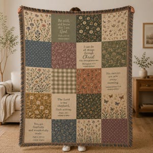 May include: A woven throw blanket featuring a patchwork design of floral patterns, polka dots, and gingham squares. The blanket displays various religious verses including Psalm 46:10, Philippians 4:13, Lamentations 3:23, Psalm 23:1, and Psalm 139:14, with fringed edges.