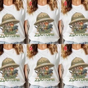 May include: White t-shirts with a Zootopia graphic featuring characters in safari hats. The shirts have text that says "Mommy", "Brother", "Daddy", "Lil Sis", "Sophie", and "Big Sis", with "Zootopia Trip 2026" below.