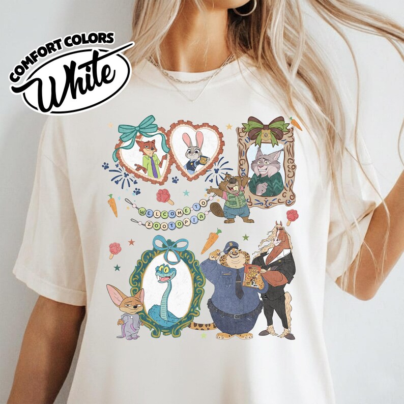 May include: A white t-shirt featuring a graphic print of Zootopia characters including Nick Wilde, Judy Hopps, and others framed in decorative hearts and ornate borders, with a banner reading Welcome to Zootopia and small carrot icons.