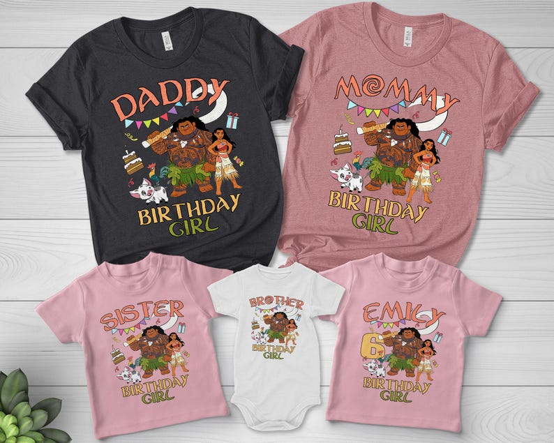 May include: A collection of five t-shirts and one baby bodysuit in black, mauve, and light pink. Each garment features a graphic print of characters from Moana, including Maui, Moana, and Pua, with text reading DADDY, MOMMY, SISTER, BROTHER, EMILY, and BIRTHDAY GIRL.