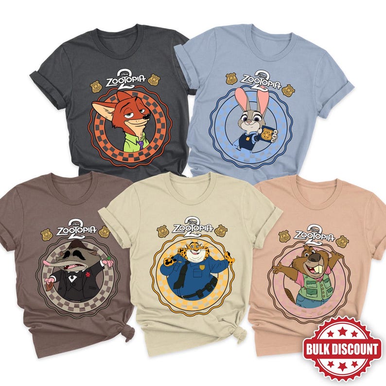 May include: Five Zootopia-themed t-shirts in various colors: charcoal, light blue, brown, tan, and peach. Each shirt features a different character from the movie within a circular design, with the Zootopia logo and police badge icons.