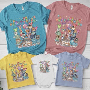 May include: A collection of colorful t-shirts and a onesie featuring a birthday party design. The design includes cartoon animals, a cake, balloons, and the word "Name". The shirts are in various colors, including blue, pink, yellow, white, and light blue.
