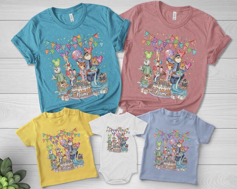 May include: A collection of colorful t-shirts and a onesie featuring a birthday party design. The design includes cartoon animals, a cake, balloons, and the word "Name". The shirts are in various colors, including blue, pink, yellow, white, and light blue.