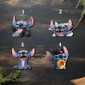 May include: Four cartoon character cutouts of Stitch from Lilo & Stitch. Each cutout features a different pose and expression. The characters are blue with large ears and a wide grin. One is sticking out its tongue, another is breaking through a paper tear.