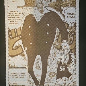 May include: A beige wallet featuring a manga-style illustration of two characters. The illustration includes text bubbles with phrases like "GYAAA" and "SLAP!" The wallet has a white border and the text "MONKEY D. GARP & MONKEY D. LUFFY (10 YEARS AGO!)".