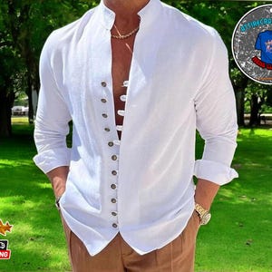May include: A white long-sleeve shirt with a mandarin collar and a button-up front. The shirt has a relaxed fit and is made of a lightweight fabric.