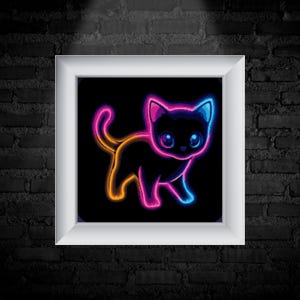 May include: A framed artwork showing a neon cat illustration. The cat is outlined in orange, pink, and blue against a black backdrop. The artwork is presented in a white frame, mounted on a dark brick wall.