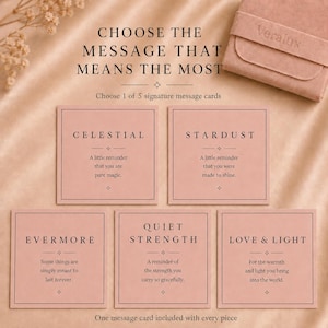 May include: Five square dusty pink message cards with black text, each featuring a unique title and sentiment: Celestial, Stardust, Evermore, Quiet Strength, and Love & Light. The cards are displayed alongside a matching pink suede jewelry pouch.