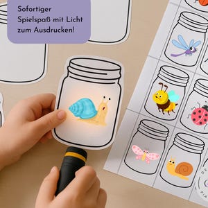 May include: A child's hand holds a flashlight illuminating a paper jar with a cartoon snail inside. Other jars with insects are printed on a sheet. Text on the image says "Instant fun with light to print!"