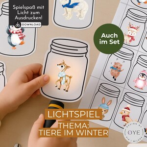 Puede incluir: Un conjunto de tarjetas de juego de luces con temática de animales de invierno. Las tarjetas presentan ilustraciones de animales como un ciervo, un pingüino y un oso dentro de tarros de cristal. El texto "JUEGO DE LUCES" y "ANIMALES DE INVIERNO" es visible, junto con la palabra "DESCARGAR".