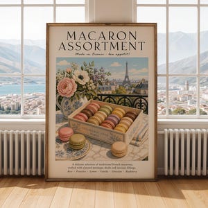 May include: A framed wall art print titled MACARON ASSORTMENT featuring a box of colourful macarons, a floral vase, and a view of the Eiffel Tower in Paris. The text includes Made in France, bon appétit, Patisserie Fine Paris, and a list of flavours.