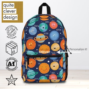 May include: A navy blue backpack featuring a colorful planet pattern with smiling suns and planets. The backpack has a front pocket with the name "Oliver" and the text "Personalize it!". The backpack also has the text "quite clever design".