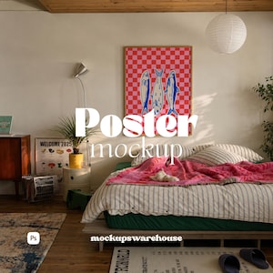 May include: A rectangular poster in a wooden frame featuring a red and pink checkerboard pattern with three blue fish illustrations, displayed on a wall above a bed with a striped duvet and a pink patterned blanket in a bedroom setting.