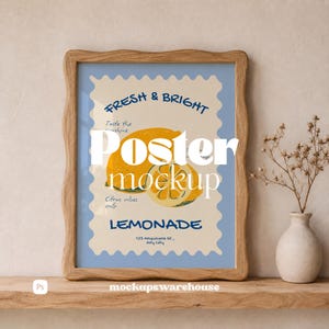 May include: A framed poster featuring a light blue background with a scalloped cream-colored border. The design includes yellow lemon illustrations, the text "FRESH & BRIGHT", "Taste the sunshine", "Citrus vibes only", "LEMONADE", and "123 Anywhere St., Any City".