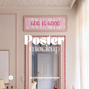 May include: A rectangular horizontal poster in a scalloped pink frame mounted on a wall. The poster features a light pink background with the text GOD IS GOOD in bold dark pink letters. The frame is positioned above a doorway with red trim.