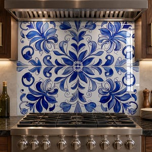 May include: A kitchen with dark wood cabinets and a stainless steel range. The backsplash features a blue and white floral tile design. A cutting board, bowl of greens, and bottles are on the countertop.