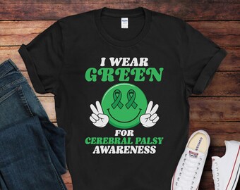 May include: Black t-shirt with green text that reads "I Wear Green for Cerebral Palsy Awareness". The text is surrounded by a green smiley face with two green ribbons.