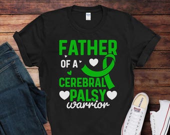 May include: Black t-shirt with white text that reads "Father of a Cerebral Palsy Warrior". A green ribbon with a white heart is above the text.