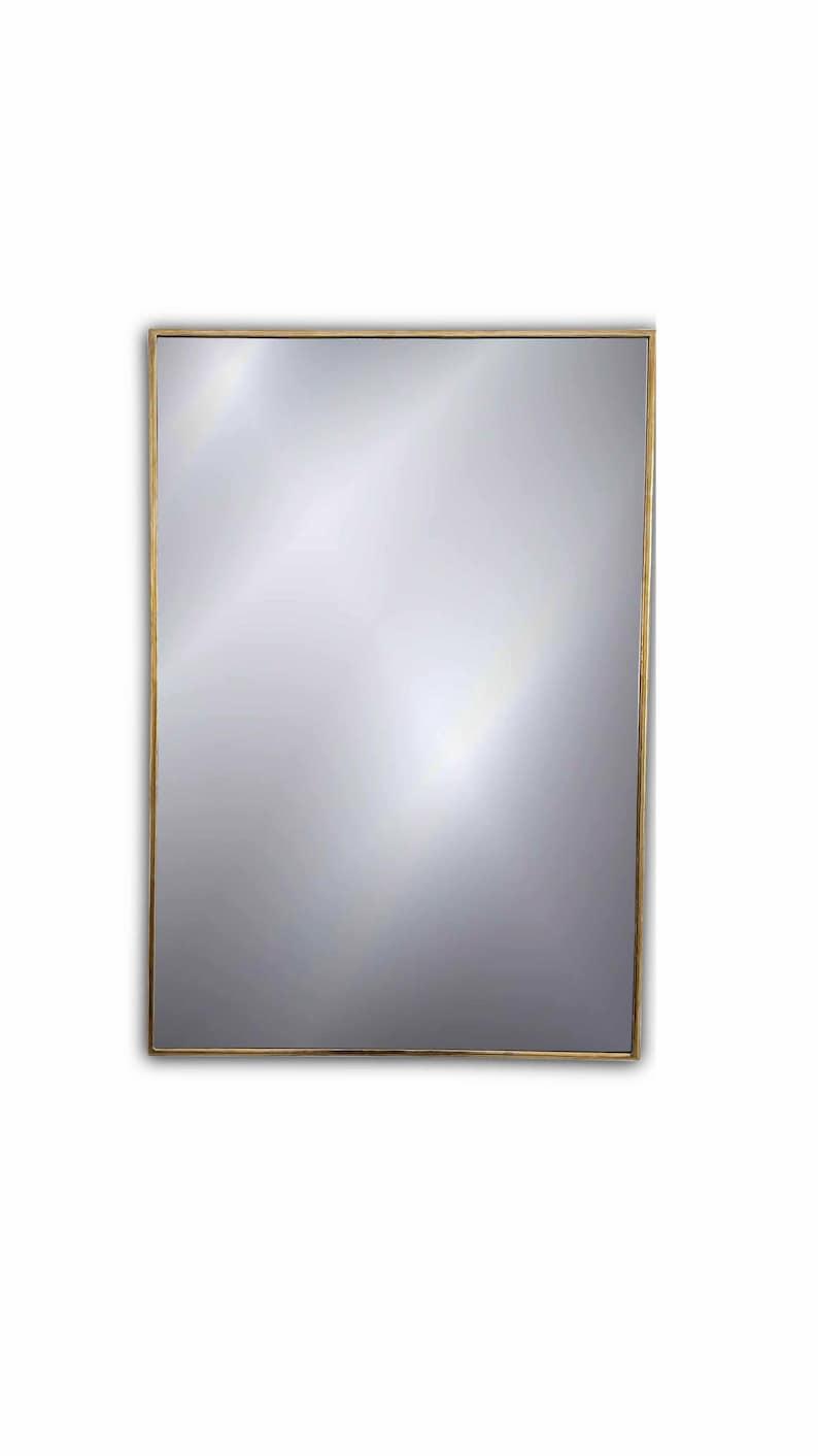 rectangle brass frame mirror in white background