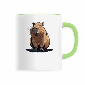 May include: White ceramic mug with a green handle and rim. The mug features a detailed illustration of a brown capybara. The capybara is sitting down with its front paws visible. The mug is a standard size.