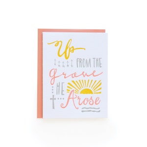 May include: A white card with a pink border features a yellow and pink graphic with the text "Up from the grave He Arose".
