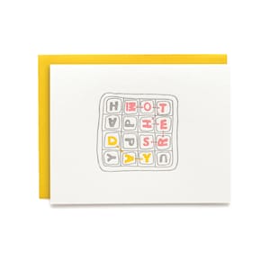 May include: A white card with a gray grid containing the letters "HAPPY BIRTHDAY" spelled out in yellow and pink. The letters are connected by red lines.