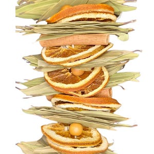 May include: A garland made of dried orange slices, cinnamon sticks, and bay leaves. The garland is a natural, rustic, and fragrant decoration.