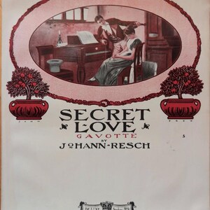 May include: A vintage sheet music cover with a red and white border. The cover features a romantic illustration of a couple in a room with a piano. The title of the sheet music is "Secret Love Gavotte" by Johann-Resch. The sheet music is published by De Luxe Music Co. in New York.