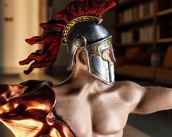 May include: A detailed sculpture of a muscular figure, possibly a warrior or deity, wearing a silver and gold helmet with a red plume. The figure has a bronze-colored shoulder guard and is posed with an outstretched arm.