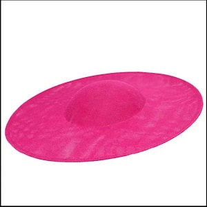 May include: A large, bright pink, wide-brimmed hat made of a textured fabric.