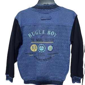 May include: Blue denim-style jacket with black sleeves. The back features the text "BUGLE BOY" above three circular logos and the word "AWARENESS". The jacket has a ribbed collar and cuffs, and a size XL tag.