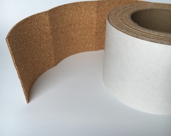 May include: A roll of cork tape with a natural brown color. The tape is partially unrolled, revealing a white backing. The cork tape is likely used for crafts, insulation, or as a decorative element.