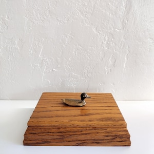 Vintage wooden box with brass duck topper