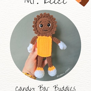 May include: A handmade crochet doll named "Mr. Reece" with a brown head and body, yellow torso, and white accents. The doll is part of the "Candy Bar Buddies" collection, as indicated by the text in the image.