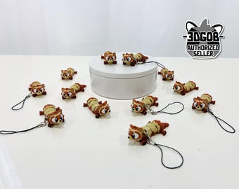 May include: A collection of small, detailed raccoon figurines with brown and tan fur, each with a black lanyard attached. The figurines are scattered on a white surface, some near a white cylindrical platform. The image includes a logo that says "3DGOB AUTHORIZED SELLER."