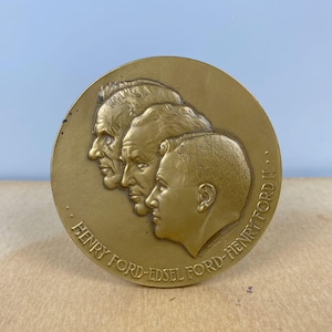 May include: A bronze medal with the profiles of Henry Ford, Edsel Ford, and Henry Ford II. The medal is inscribed "Henry Ford-Edsel Ford-Henry Ford II."