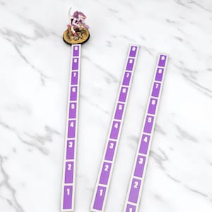 May include: A miniature figurine in purple and white sits near three rectangular game markers. The markers are purple with white numbers from 1 to 9. The figurine is mounted on a brown base. The items are for a tabletop game.